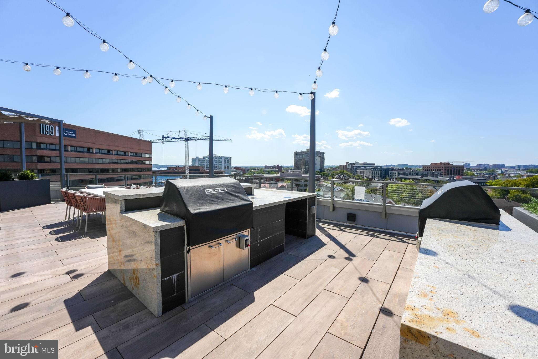 1201 North Royal Street, Unit 214 Alexandria, VA 22314 - Photo 48 of 71 a kitchen with stainless steel appliances kitchen island granite countertop a stove a sink and a microwave