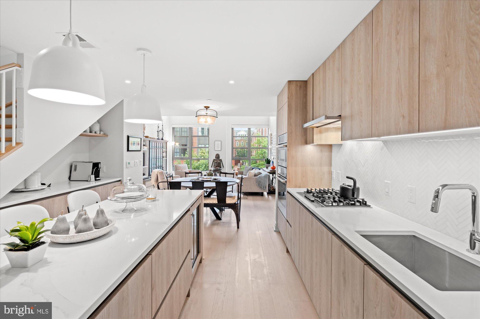 1201 North Royal Street, Unit 214 Alexandria, VA 22314 - Photo 5 of 71 Modern kitchen with sleek wood accents.