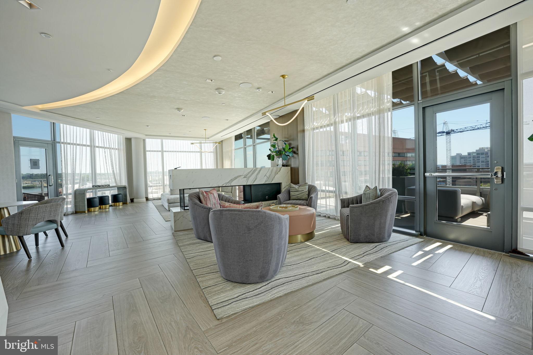 1201 North Royal Street, Unit 214 Alexandria, VA 22314 - Photo 59 of 71 a living room with furniture a wooden floor and a large window