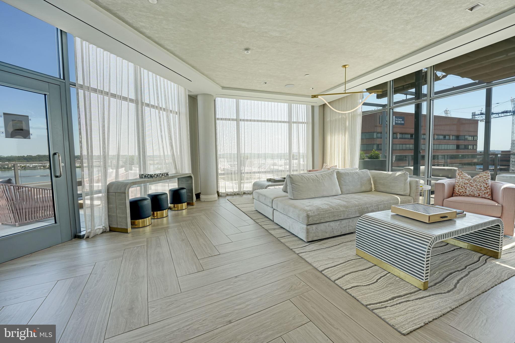 1201 North Royal Street, Unit 214 Alexandria, VA 22314 - Photo 60 of 71 a living room with furniture and large windows