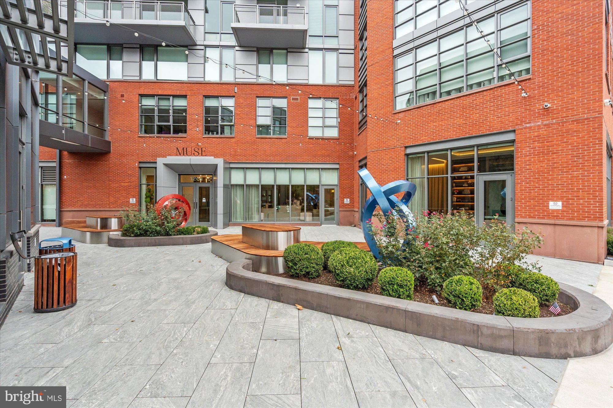 1201 North Royal Street, Unit 214 Alexandria, VA 22314 - Photo 69 of 71 Modern urban courtyard with vibrant sculptures.