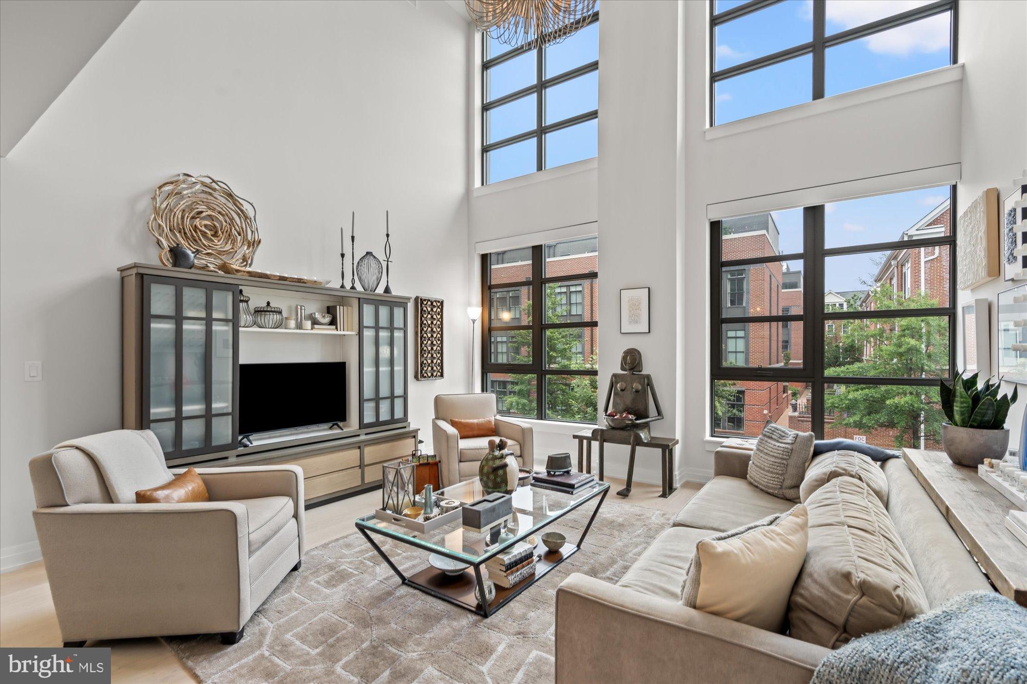 1201 North Royal Street, Unit 214 Alexandria, VA 22314 - Photo 9 of 71 a living room with furniture a floor to ceiling window and a flat screen tv