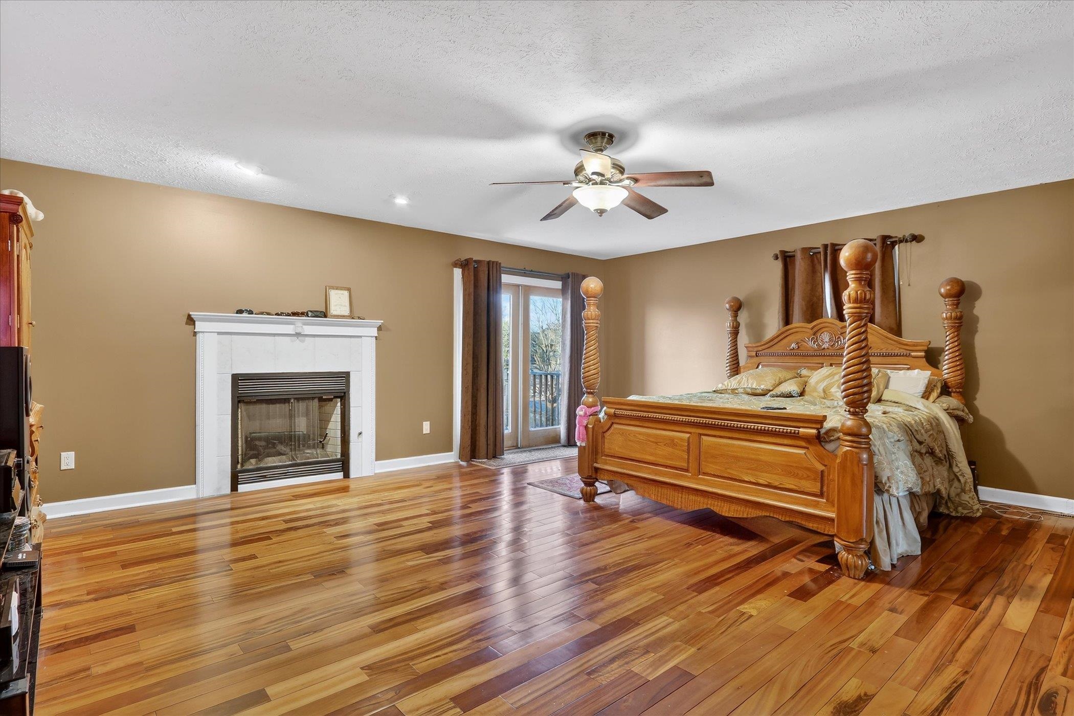 8306 East Crockett Road Roscoe, IL 61073 - Photo 15 of 61 a spacious bedroom with a bed and wooden floor