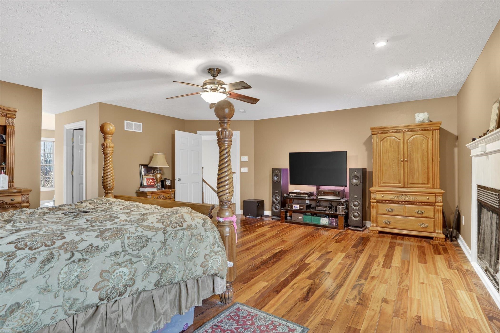 8306 East Crockett Road Roscoe, IL 61073 - Photo 16 of 61 a bedroom with a bed and wooden floor