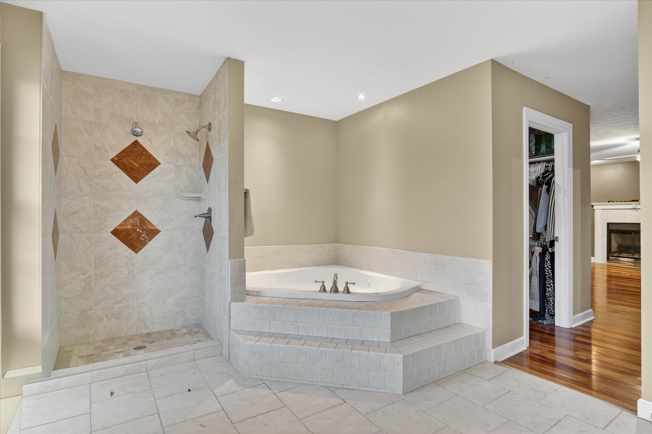 8306 East Crockett Road Roscoe, IL 61073 - Photo 17 of 61 a bathroom with a bathtub and shower