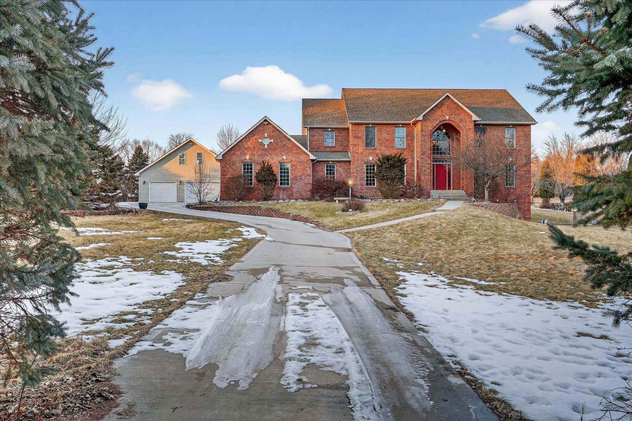 8306 East Crockett Road Roscoe, IL 61073 - Photo 25 of 61 a front view of a house with a yard