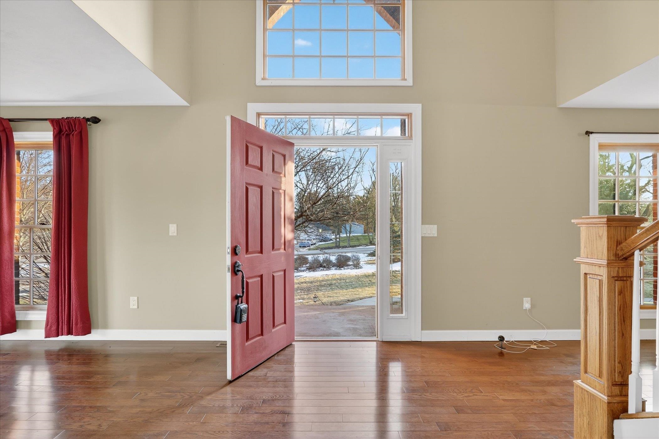 8306 East Crockett Road Roscoe, IL 61073 - Photo 3 of 61 a view of a hallway with wooden floor and a living room