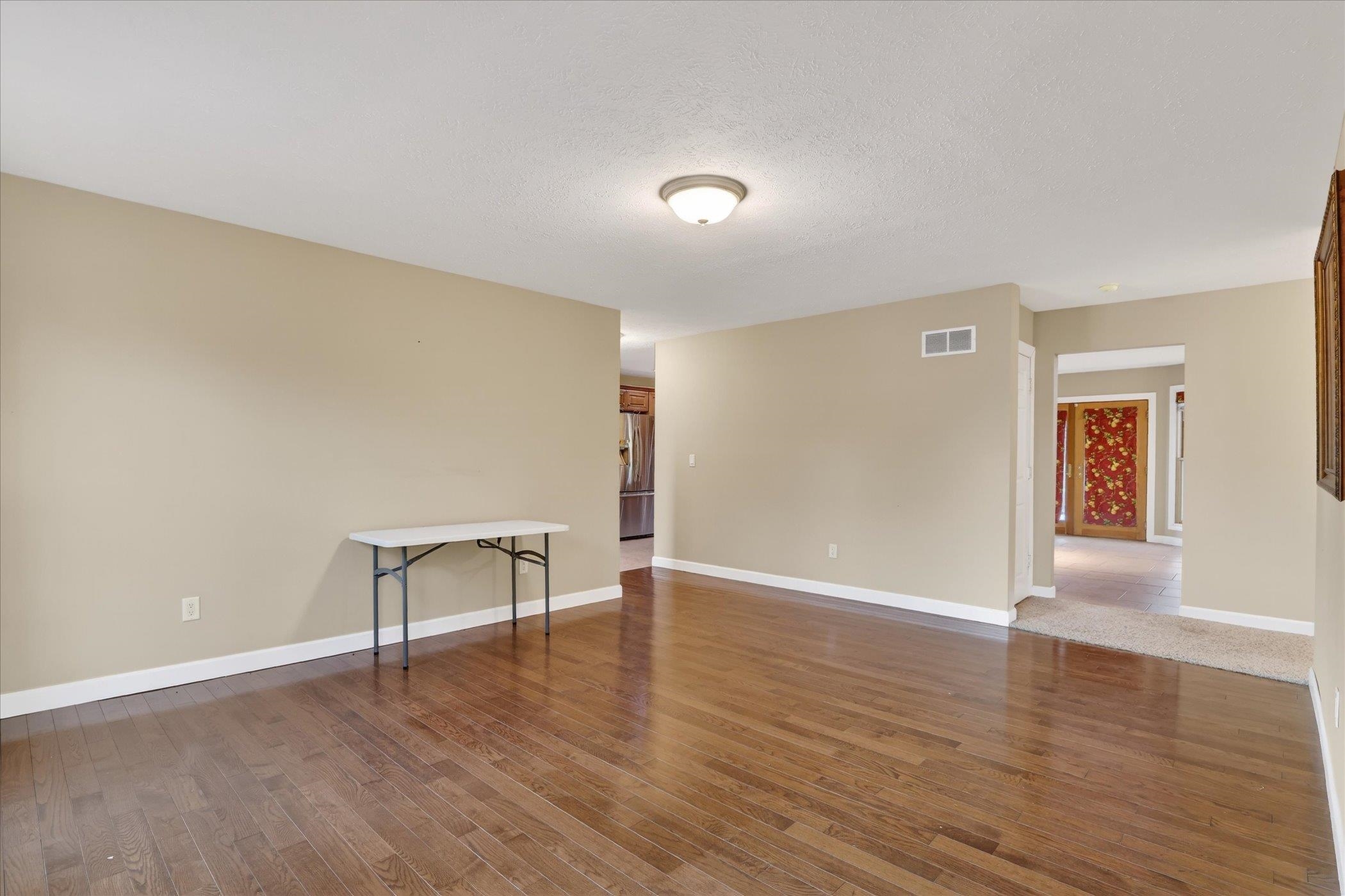 8306 East Crockett Road Roscoe, IL 61073 - Photo 32 of 61 a view of an empty room with wooden floor