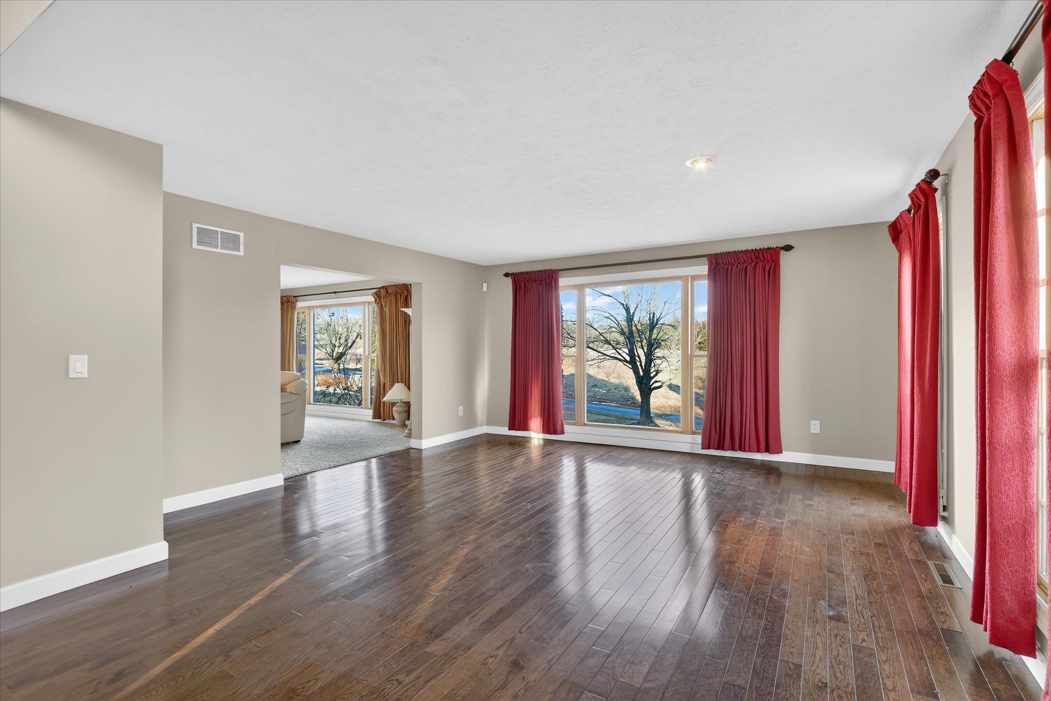 8306 East Crockett Road Roscoe, IL 61073 - Photo 34 of 61 a view of an empty room with wooden floor and a window