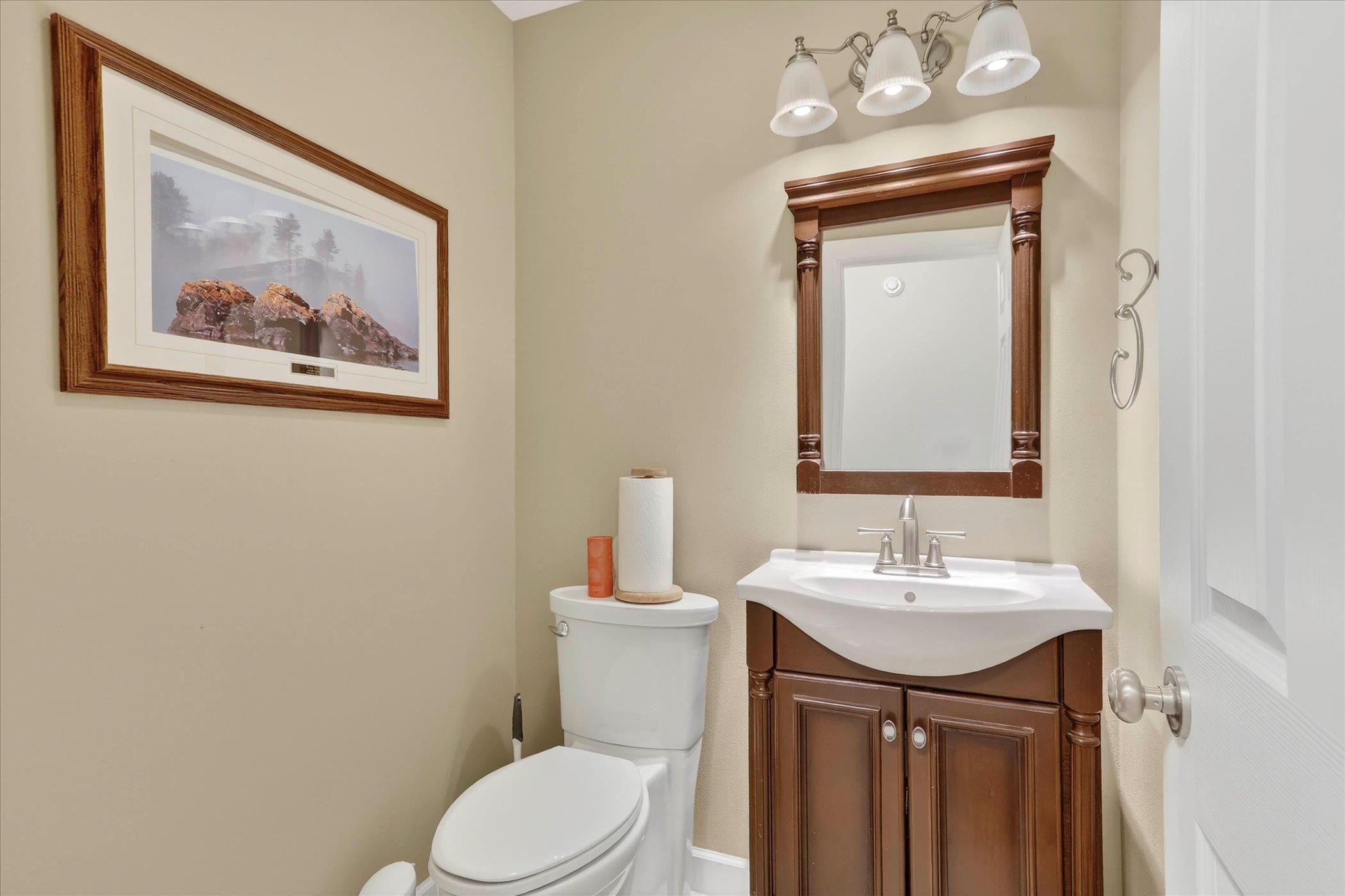 8306 East Crockett Road Roscoe, IL 61073 - Photo 37 of 61 a bathroom with a toilet sink and mirror
