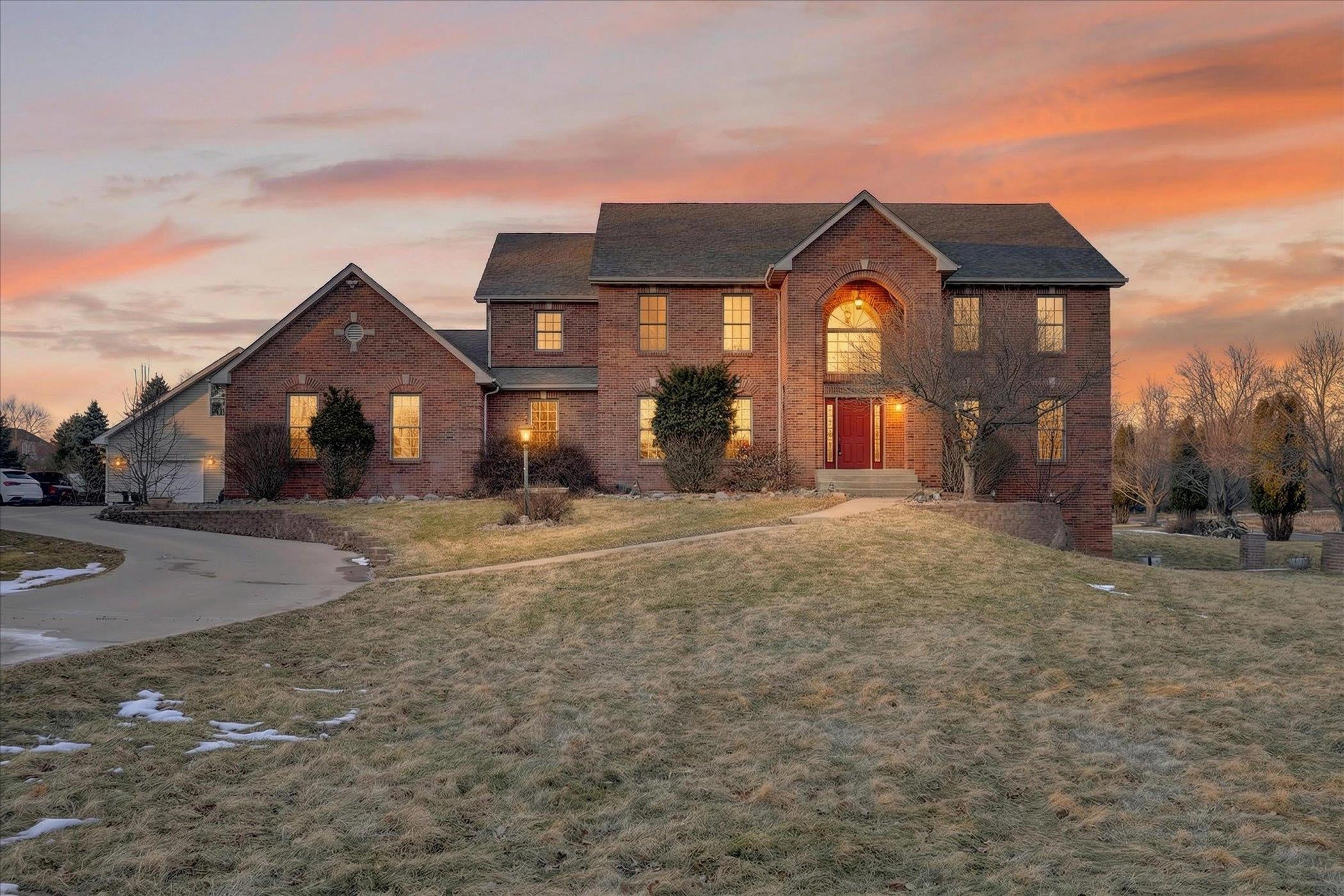 8306 East Crockett Road Roscoe, IL 61073 - Photo 40 of 61 a front view of a house with a yard