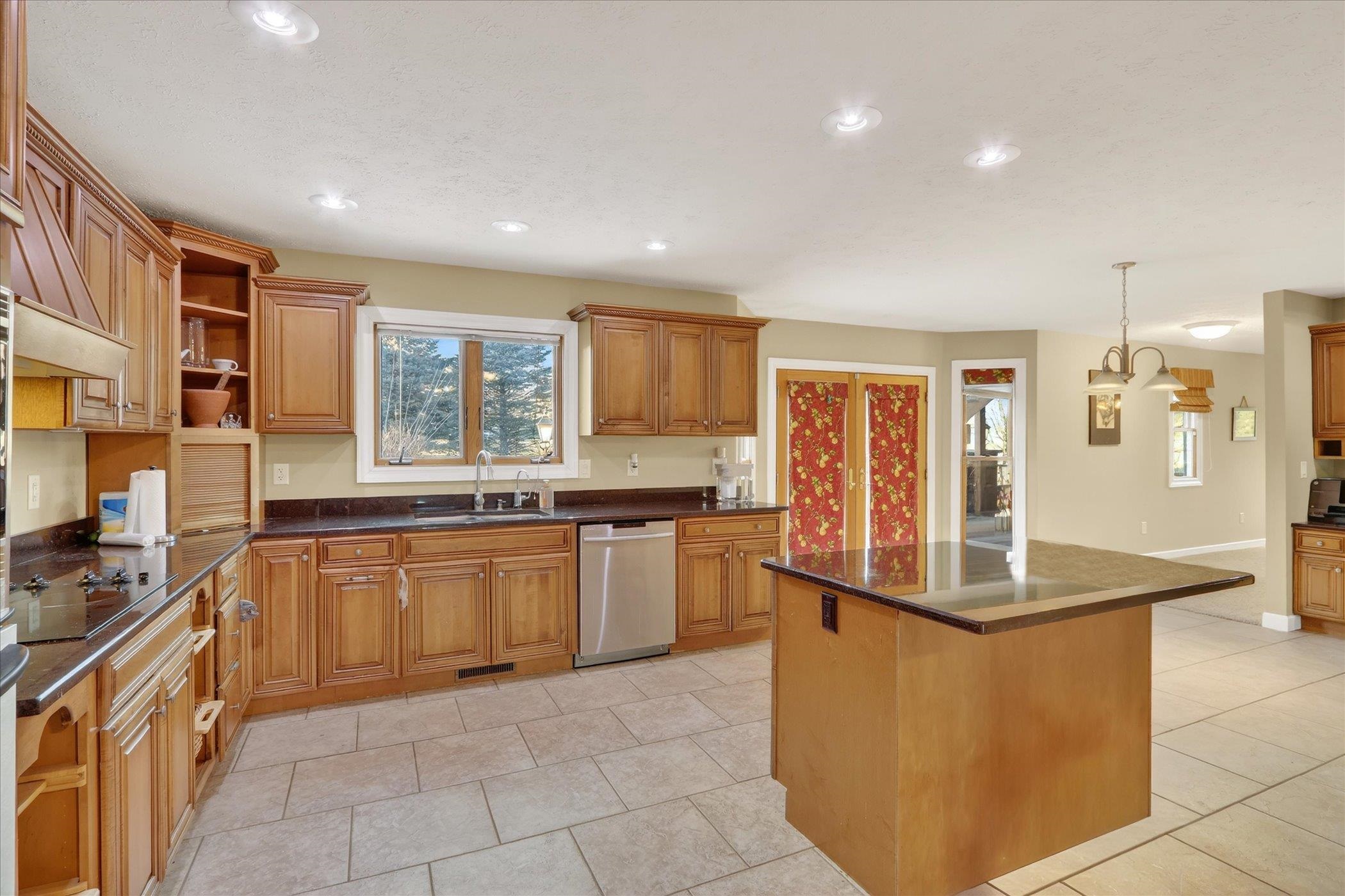 8306 East Crockett Road Roscoe, IL 61073 - Photo 44 of 61 a kitchen with stainless steel appliances granite countertop a refrigerator and a stove top oven