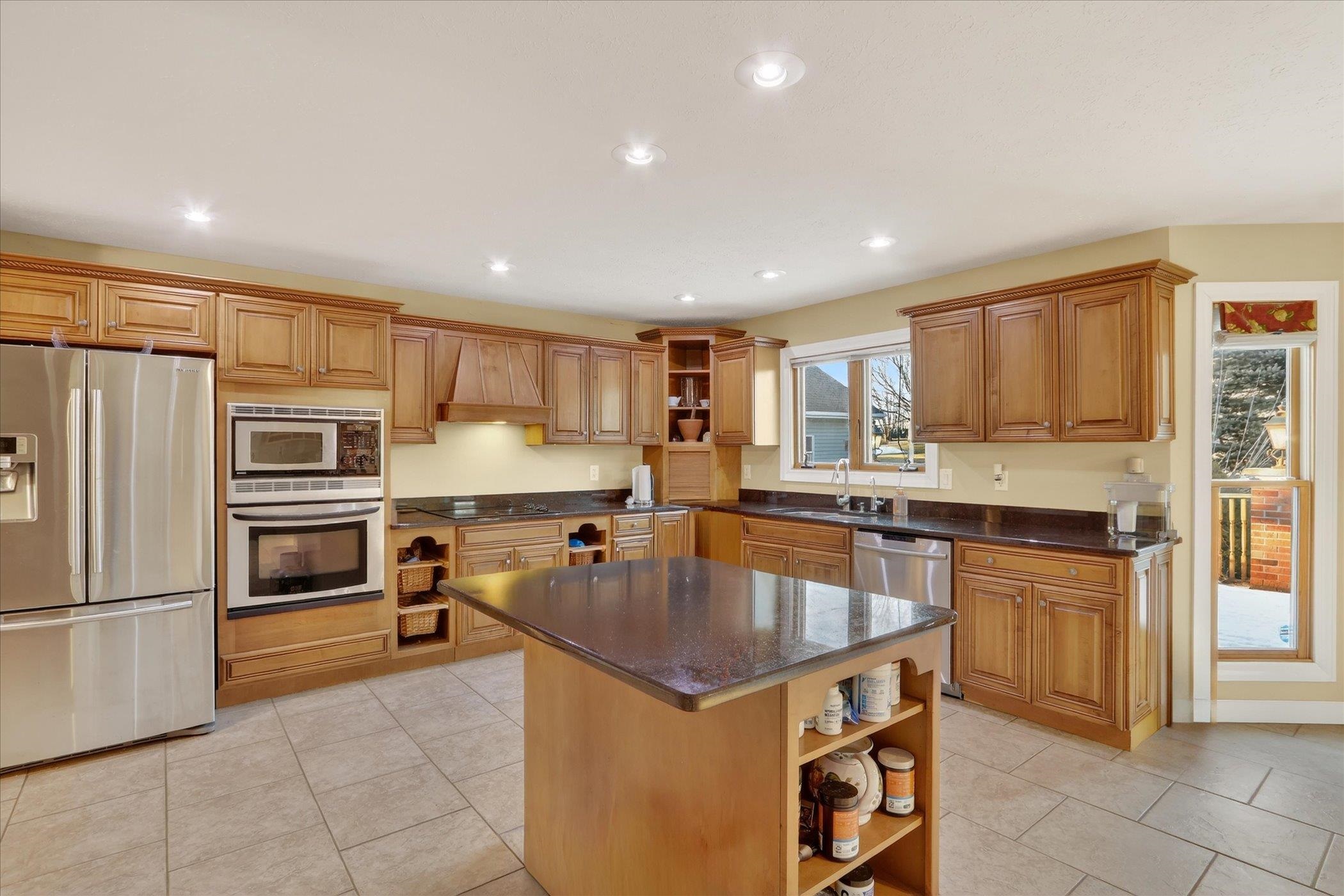 8306 East Crockett Road Roscoe, IL 61073 - Photo 45 of 61 a kitchen with kitchen island a counter top space stainless steel appliances and a window