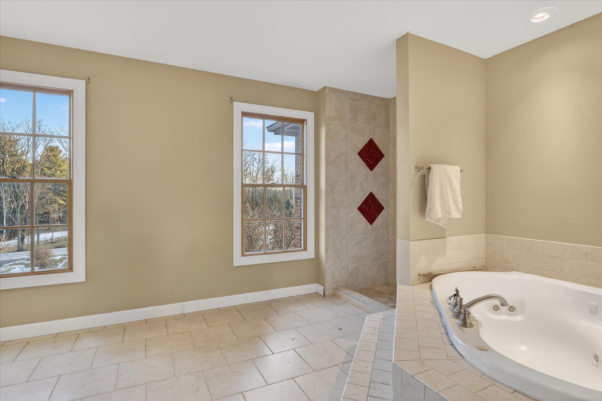 8306 East Crockett Road Roscoe, IL 61073 - Photo 51 of 61 a bathroom with a tub sink and mirror