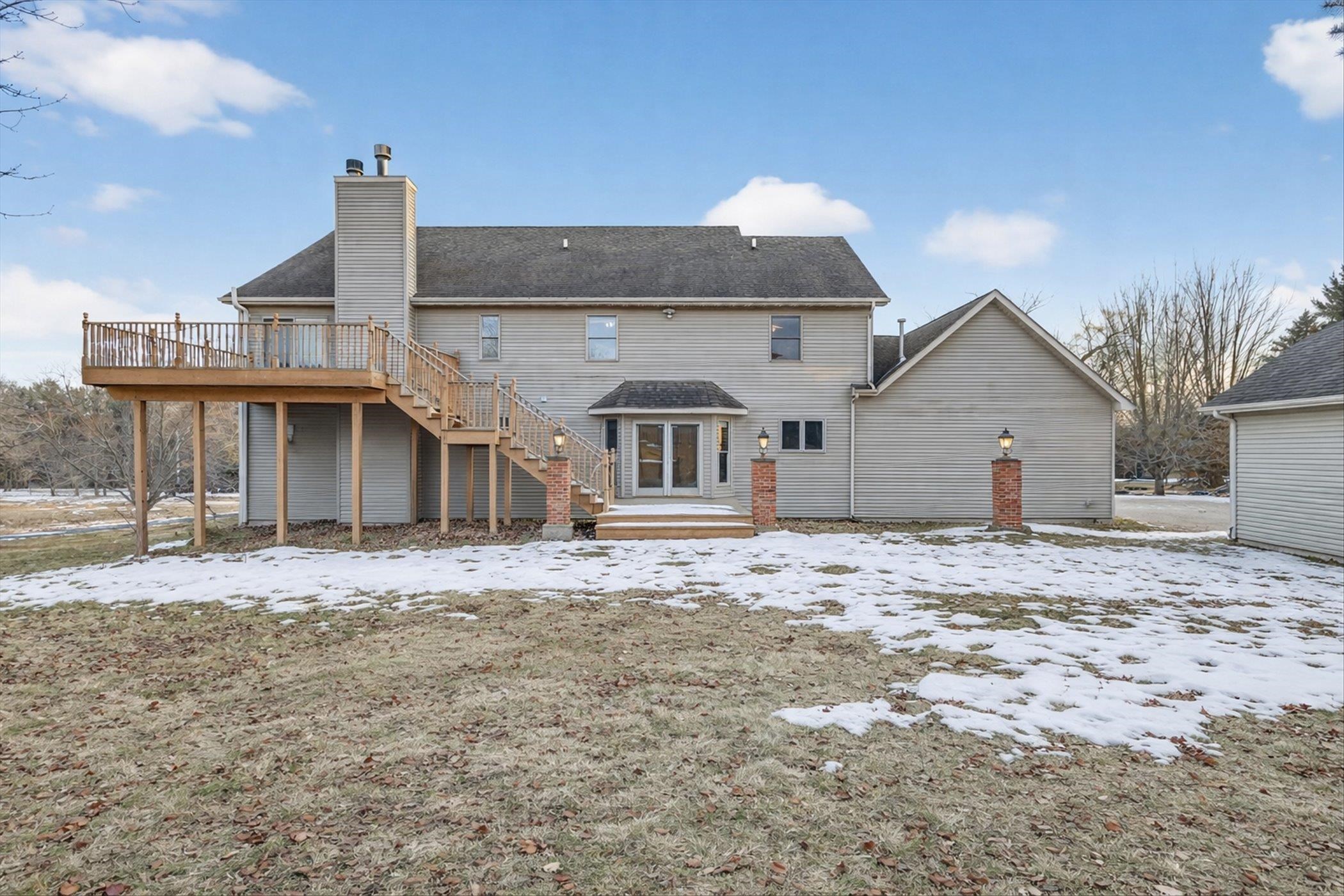 8306 East Crockett Road Roscoe, IL 61073 - Photo 59 of 61 a front view of a house with a dirt yard and a large tree