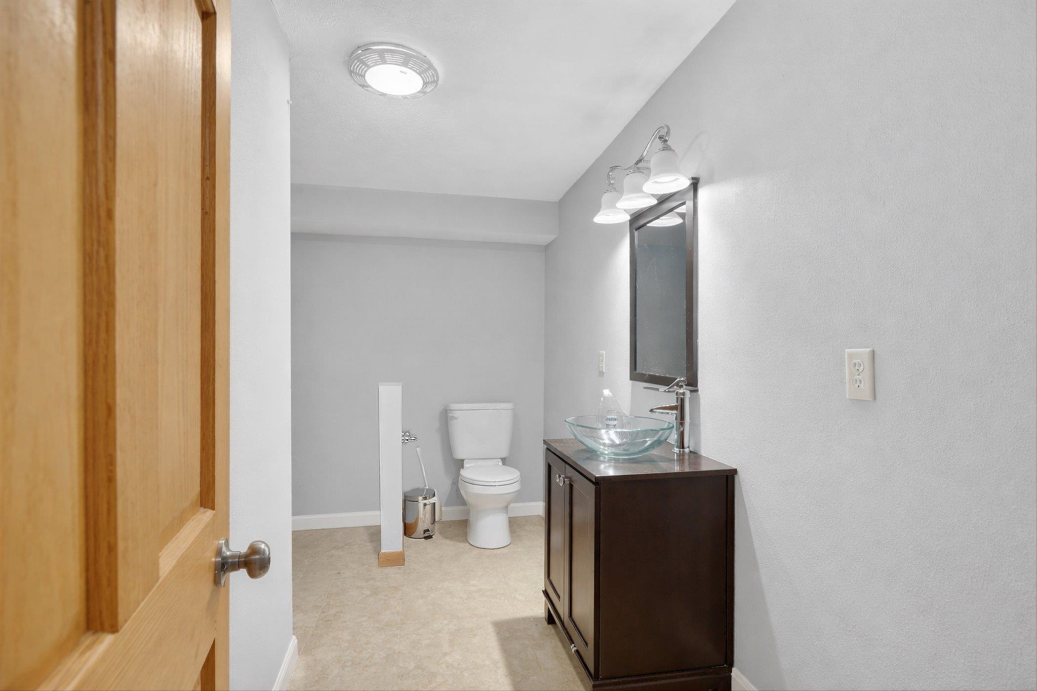 8306 East Crockett Road Roscoe, IL 61073 - Photo 6 of 61 a bathroom with a sink and a mirror
