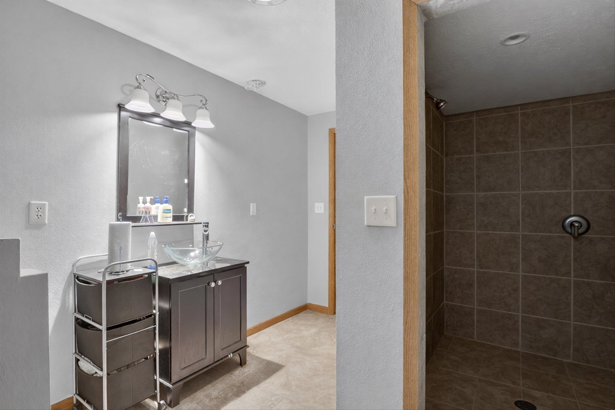 8306 East Crockett Road Roscoe, IL 61073 - Photo 7 of 61 a bathroom with a sink shower and a mirror