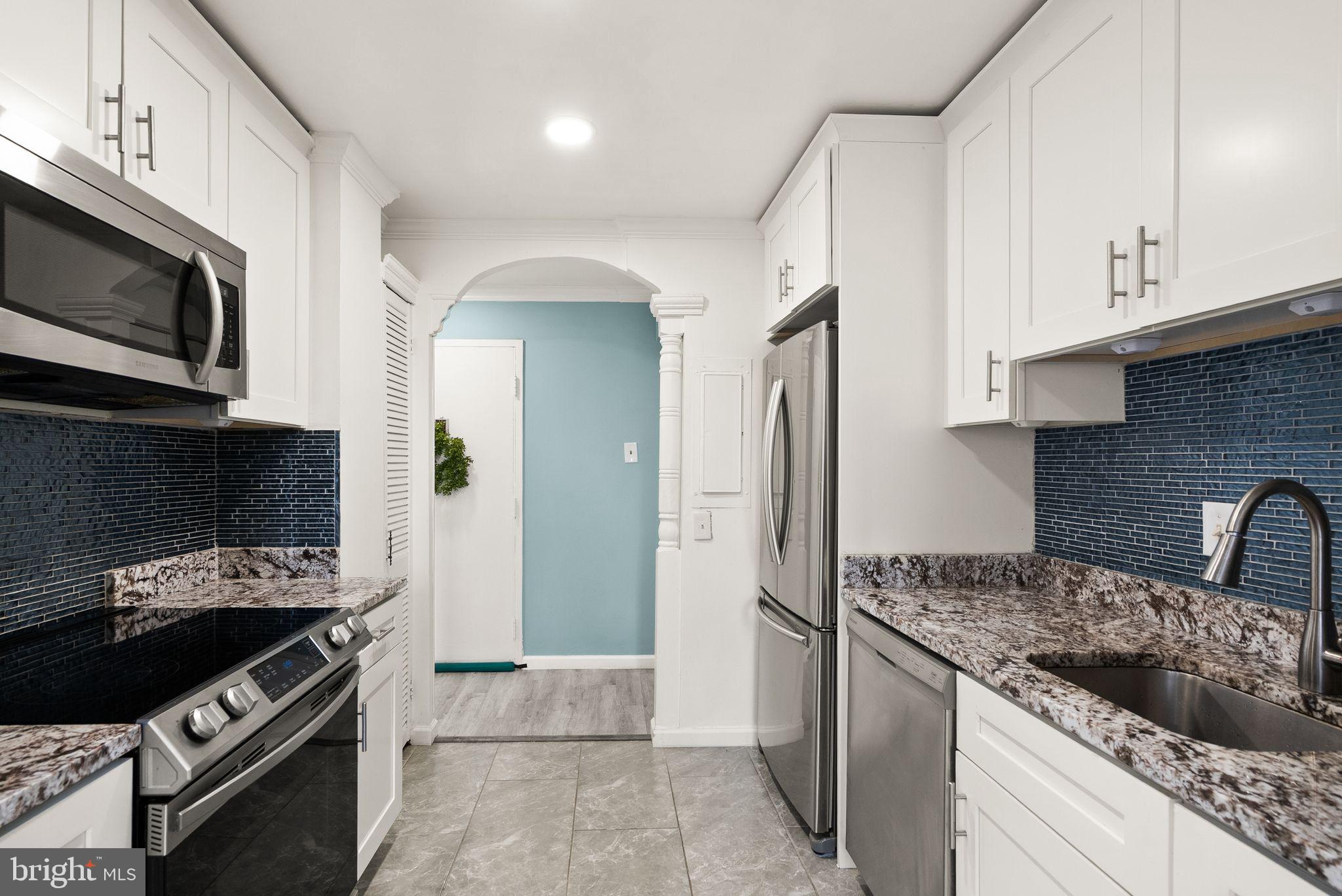 3245 Rio Drive, Unit 608 Falls Church, VA 22041 - Photo 14 of 36 a kitchen with stainless steel appliances granite countertop a stove and a refrigerator