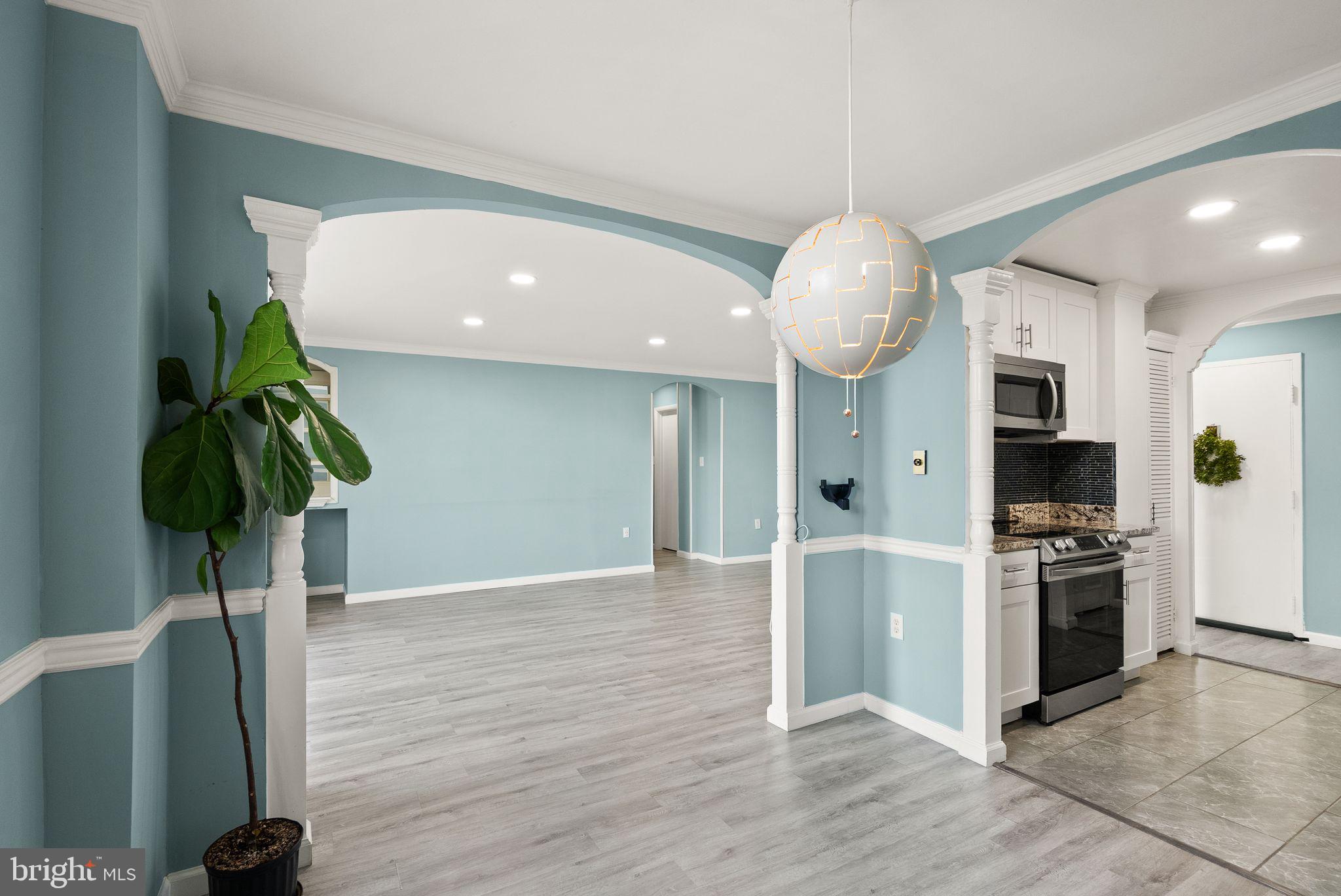 3245 Rio Drive, Unit 608 Falls Church, VA 22041 - Photo 20 of 36 a kitchen with stainless steel appliances granite countertop a sink a stove a refrigerator and a wooden floor