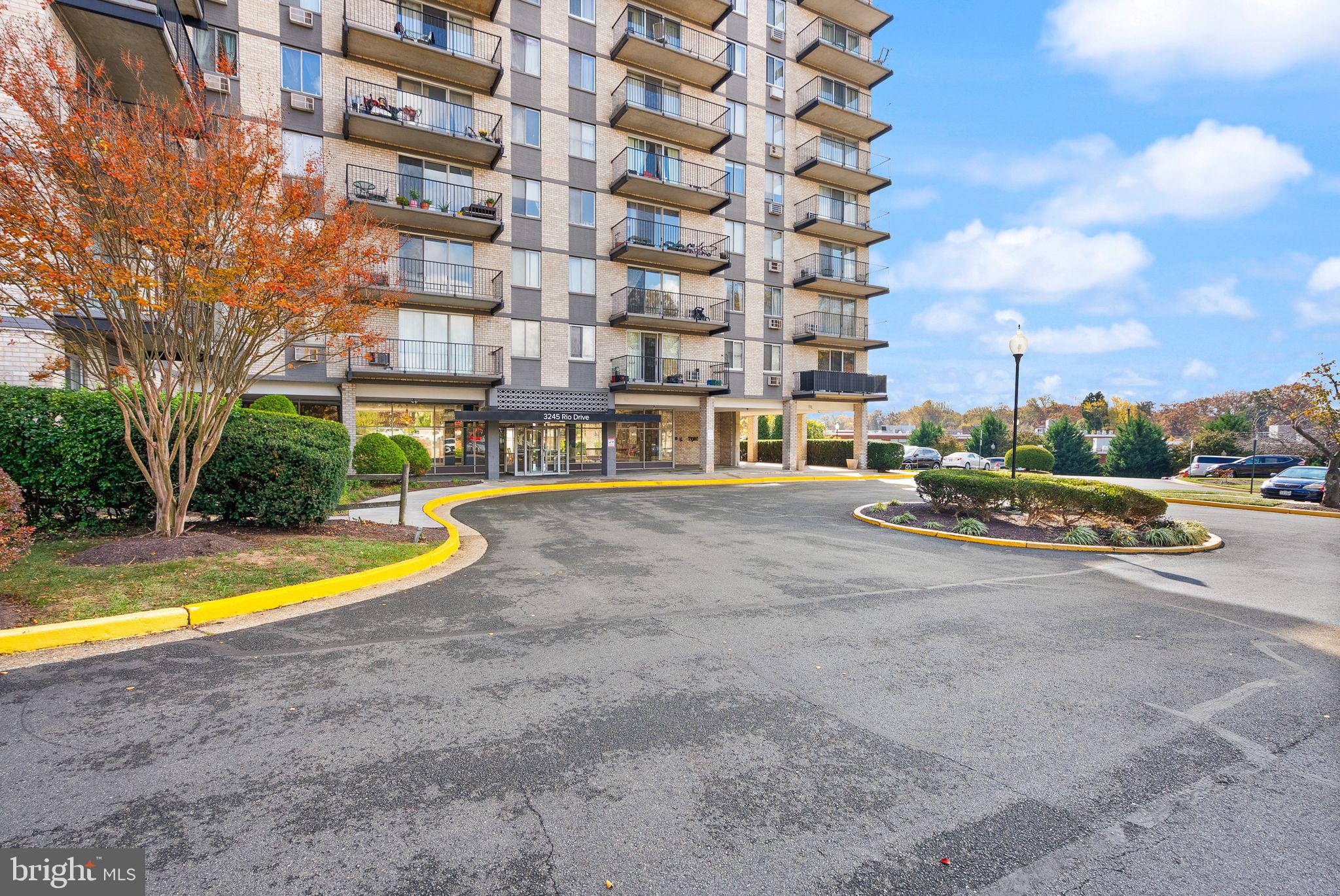 3245 Rio Drive, Unit 608 Falls Church, VA 22041 - Photo 4 of 36 a view of a swimming pool with a lawn chairs and a yard