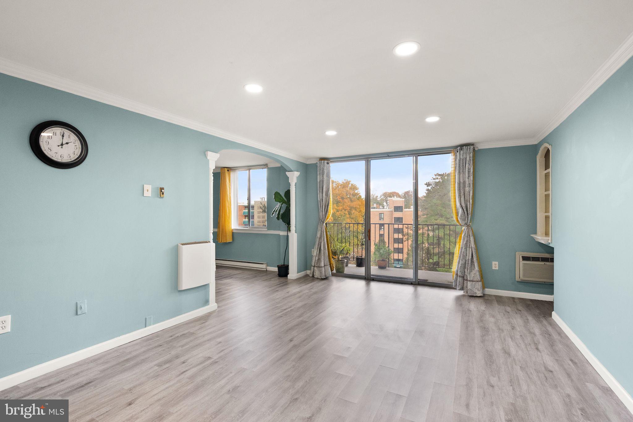 3245 Rio Drive, Unit 608 Falls Church, VA 22041 - Photo 9 of 36 a view of an empty room with glass door and a window
