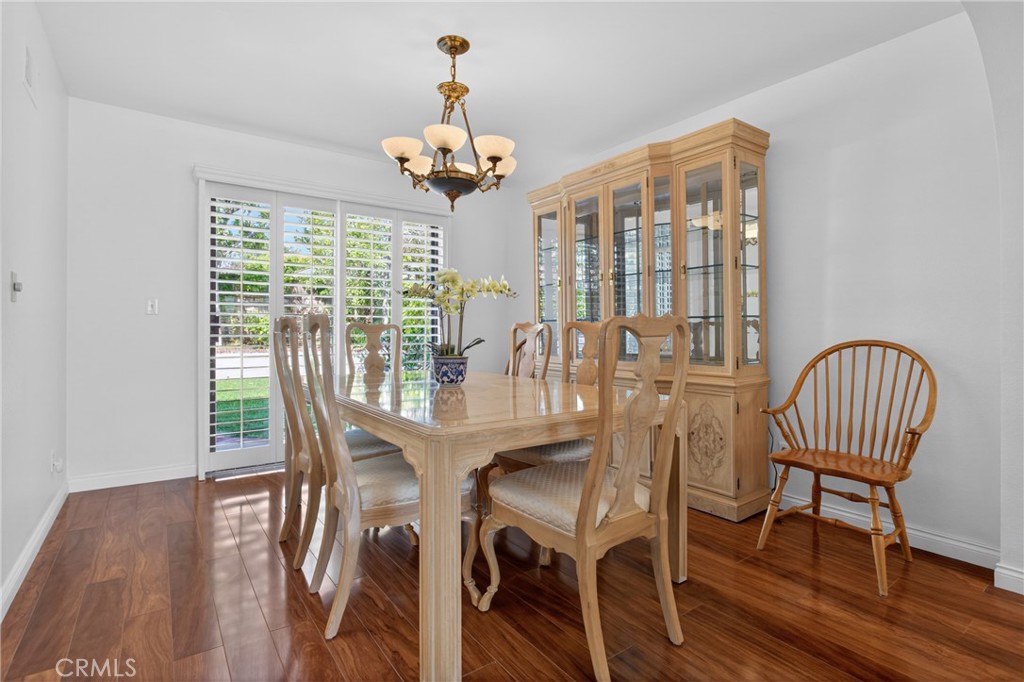 12231 Eagle Ridge Way Porter Ranch, CA 91326 - Photo 17 of 65 a view of a dining room with furniture wooden floor and chandelier
