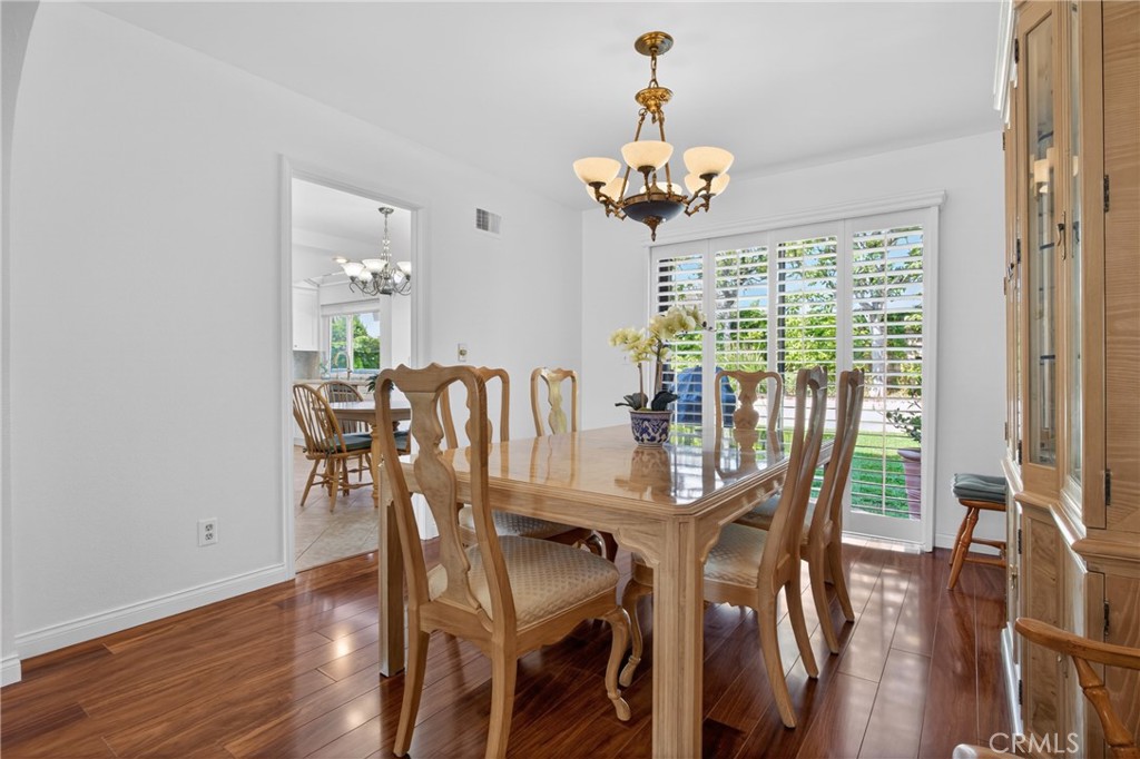 12231 Eagle Ridge Way Porter Ranch, CA 91326 - Photo 18 of 65 a view of a dining room with furniture a chandelier and wooden floor