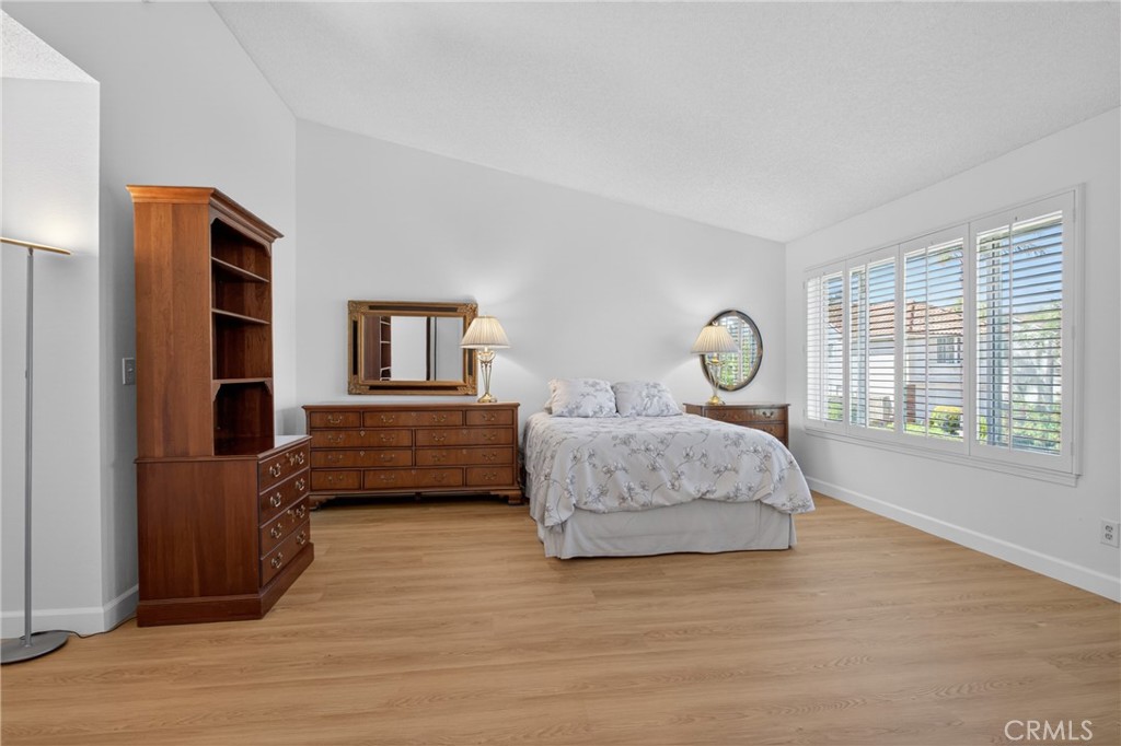 12231 Eagle Ridge Way Porter Ranch, CA 91326 - Photo 23 of 65 a bedroom with a bed and wooden floor