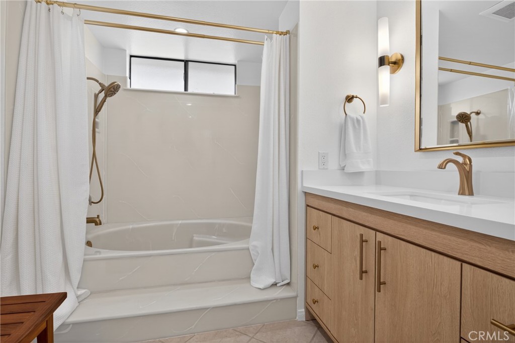 12231 Eagle Ridge Way Porter Ranch, CA 91326 - Photo 25 of 65 a bathroom with a granite countertop sink mirror and a bathtub