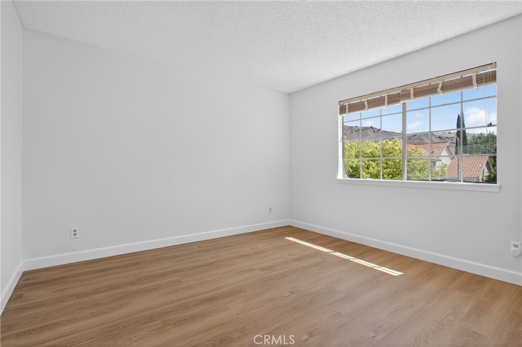 12231 Eagle Ridge Way Porter Ranch, CA 91326 - Photo 27 of 65 wooden floor in an empty room with a window
