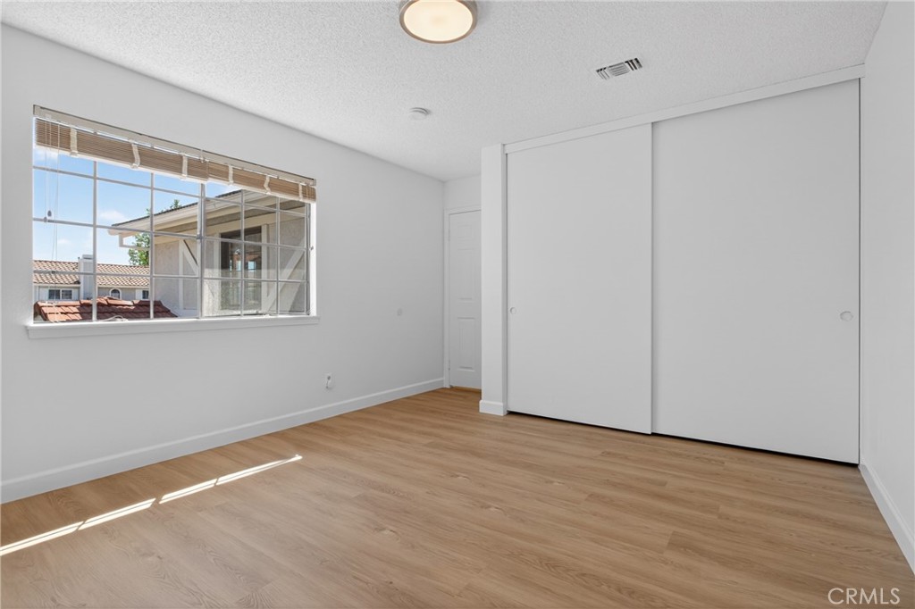 12231 Eagle Ridge Way Porter Ranch, CA 91326 - Photo 29 of 65 a view of an empty room with wooden floor and a window