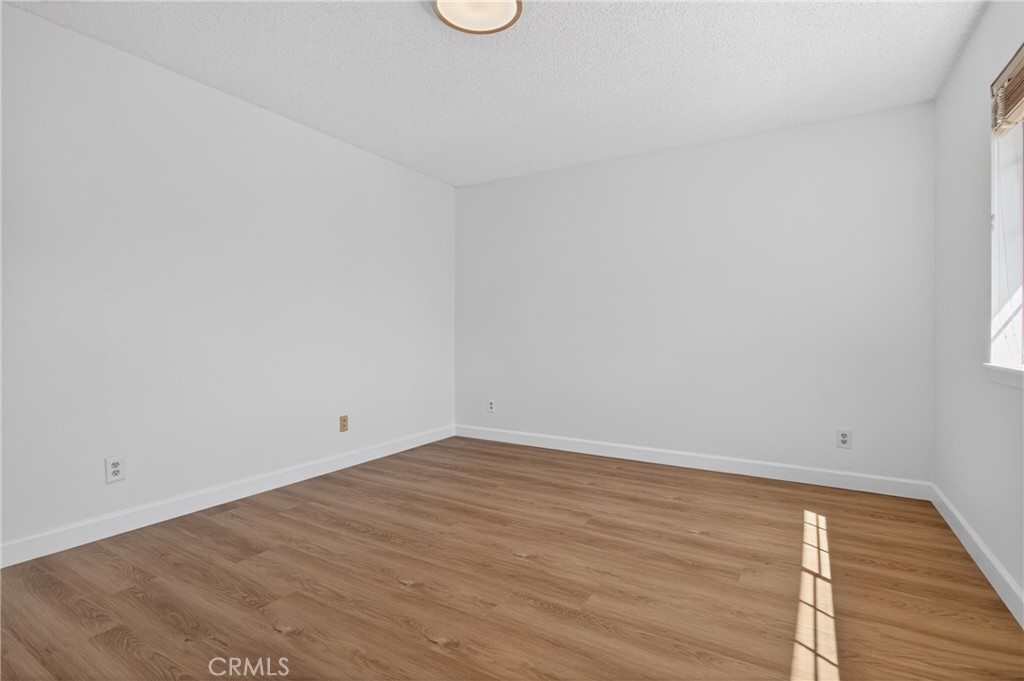 12231 Eagle Ridge Way Porter Ranch, CA 91326 - Photo 32 of 65 a view of an empty room with wooden floor and a window