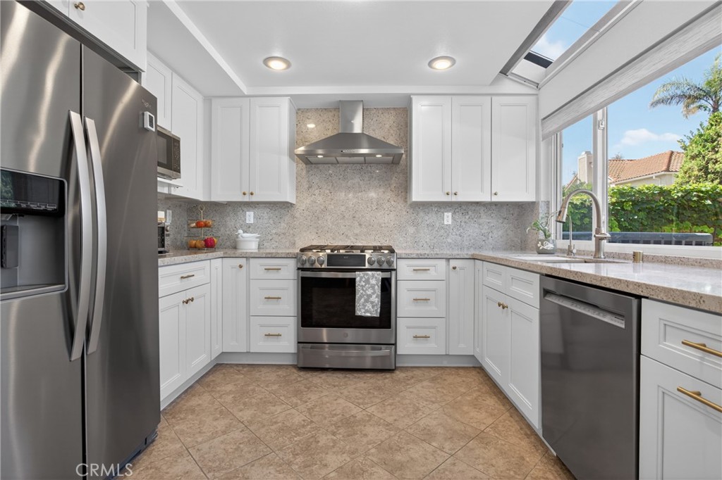 12231 Eagle Ridge Way Porter Ranch, CA 91326 - Photo 4 of 65 a kitchen with stainless steel appliances granite countertop a refrigerator sink and stove