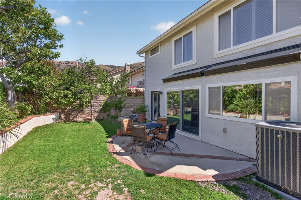 12231 Eagle Ridge Way Porter Ranch, CA 91326 - Photo 43 of 65 a view of a house with backyard sitting area and garden