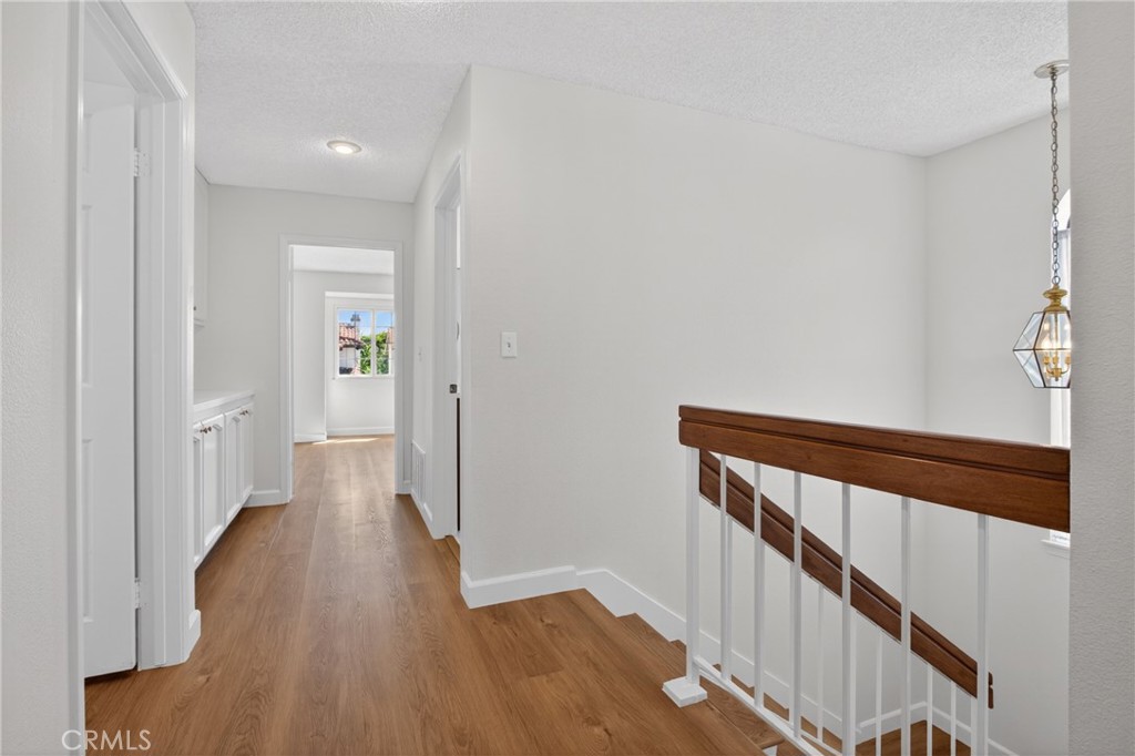 12231 Eagle Ridge Way Porter Ranch, CA 91326 - Photo 58 of 65 a view of a hallway with wooden floor