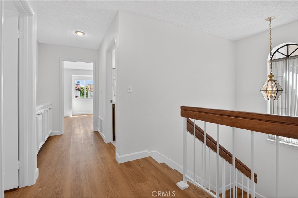 12231 Eagle Ridge Way Porter Ranch, CA 91326 - Photo 59 of 65 a view of a hallway with wooden floor