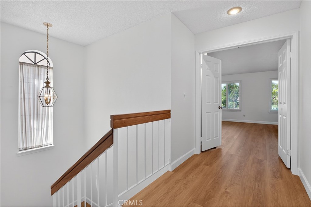 12231 Eagle Ridge Way Porter Ranch, CA 91326 - Photo 60 of 65 a view of a hallway view with wooden floor and staircase