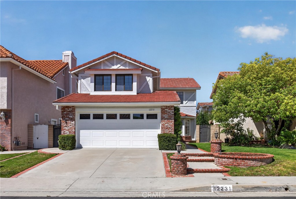 12231 Eagle Ridge Way Porter Ranch, CA 91326 - Photo 62 of 65 a front view of a house with a yard and garage