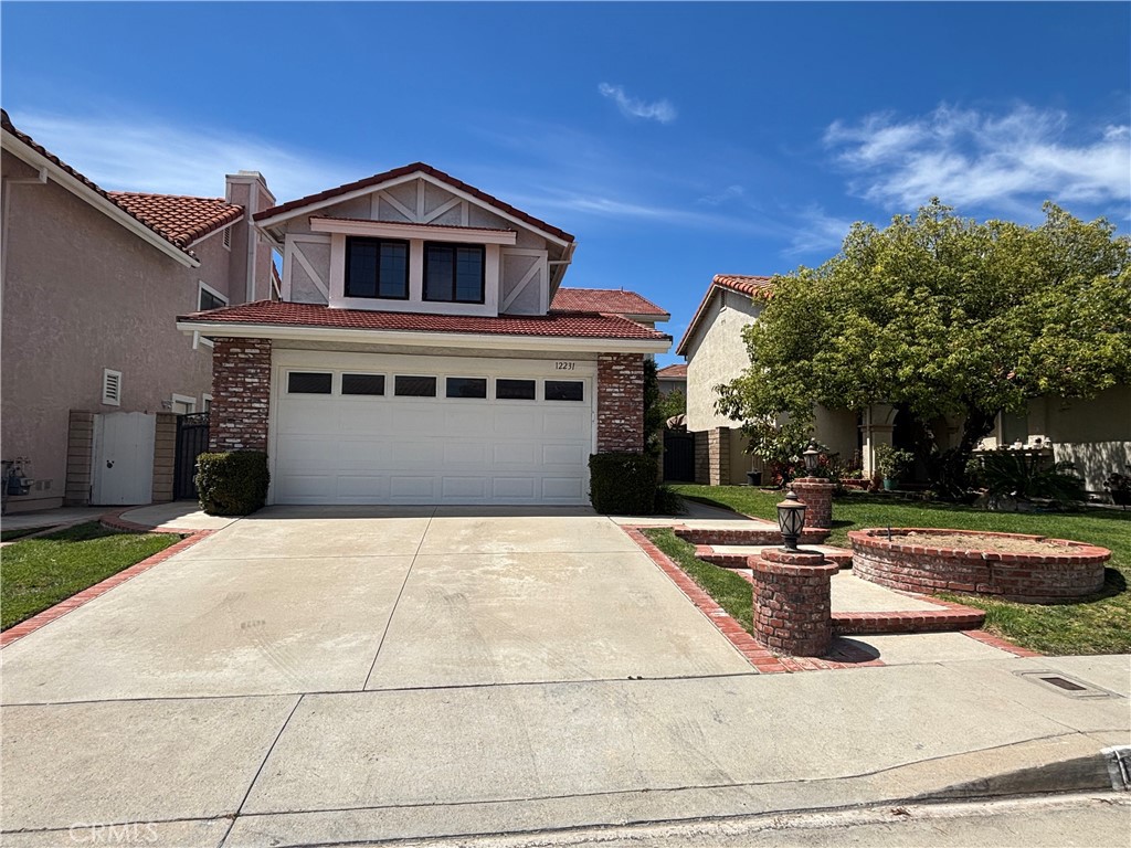 12231 Eagle Ridge Way Porter Ranch, CA 91326 - Photo 65 of 65 a front view of a house with a yard