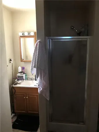 a bathroom with a sink vanity and a mirror