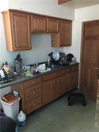 a kitchen with a cabinets and wooden floor