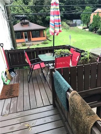 a view of a deck with couches table and chairs