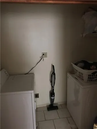 a view of storage and utility room with washer and dryer