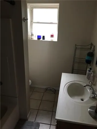 a bathroom with a sink and a window