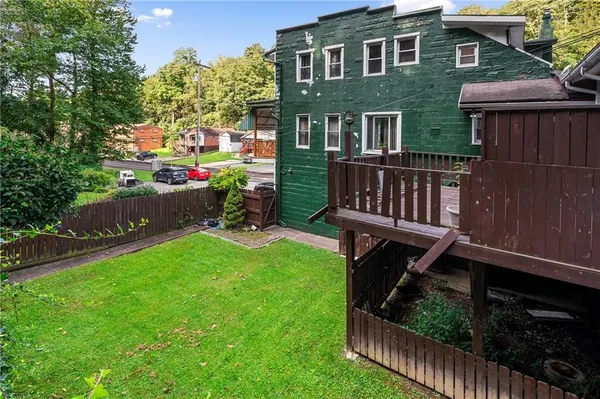 a view of house with backyard and sitting area