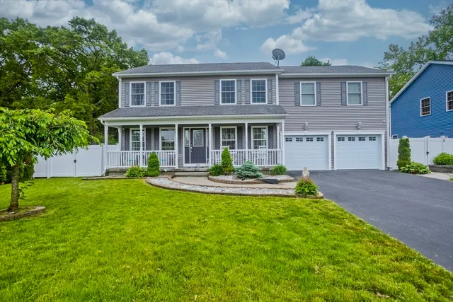 a front view of a house with a yard table and chairs