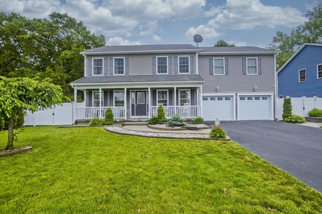 a front view of a house with a yard table and chairs