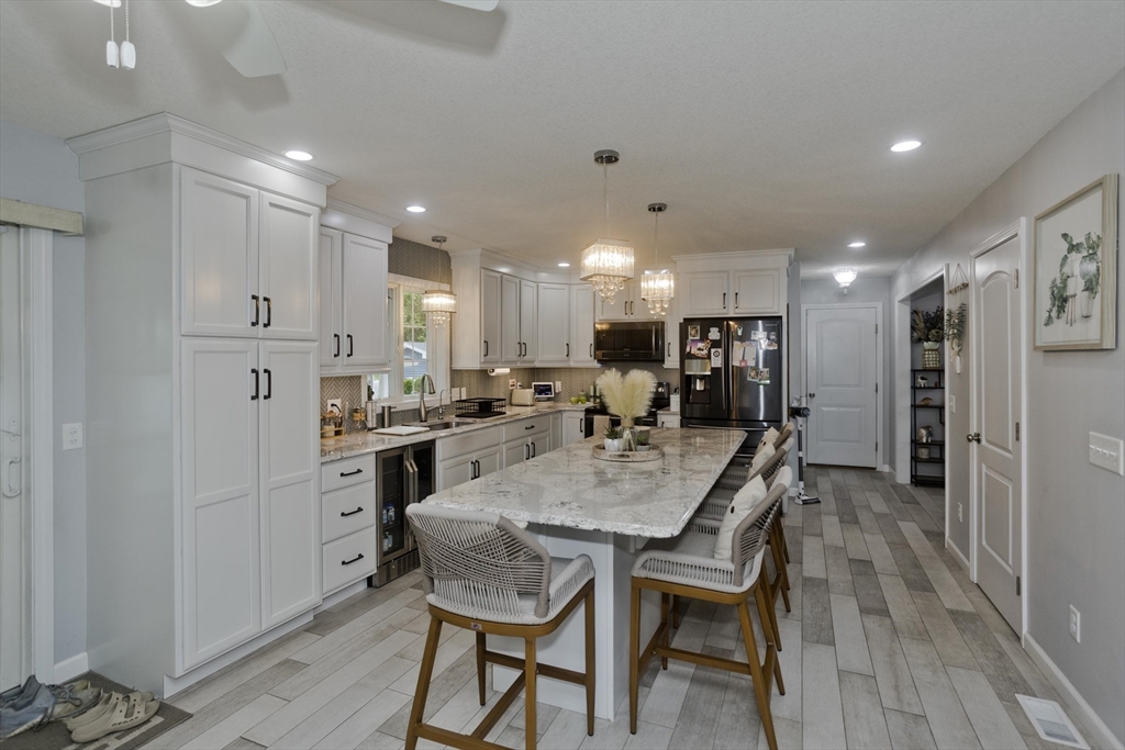 210 Naismith Street Springfield, MA 01104 - Photo 12 of 42 a large kitchen with dining table and chairs