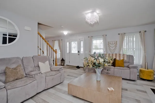 a living room with furniture chandelier and couch