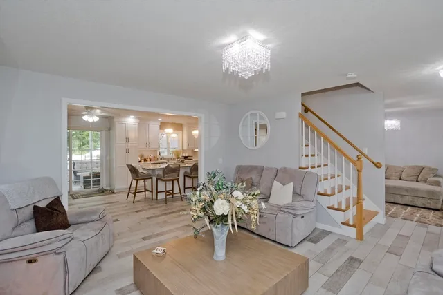 a living room with furniture and a chandelier